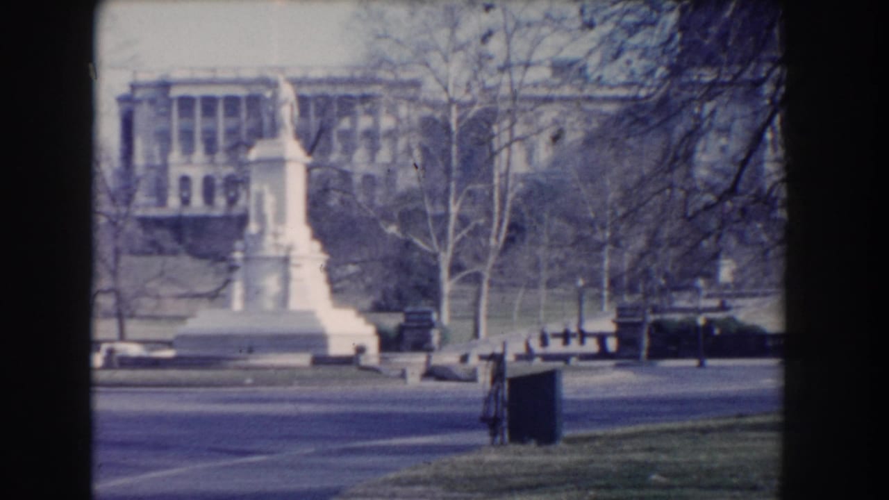 White monument and park roadway seen through soft 8mm film framing.