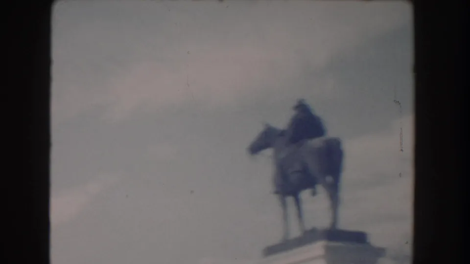 Washington, DC landmark view with an equestrian statue silhouetted softly against a muted 1960s sky.