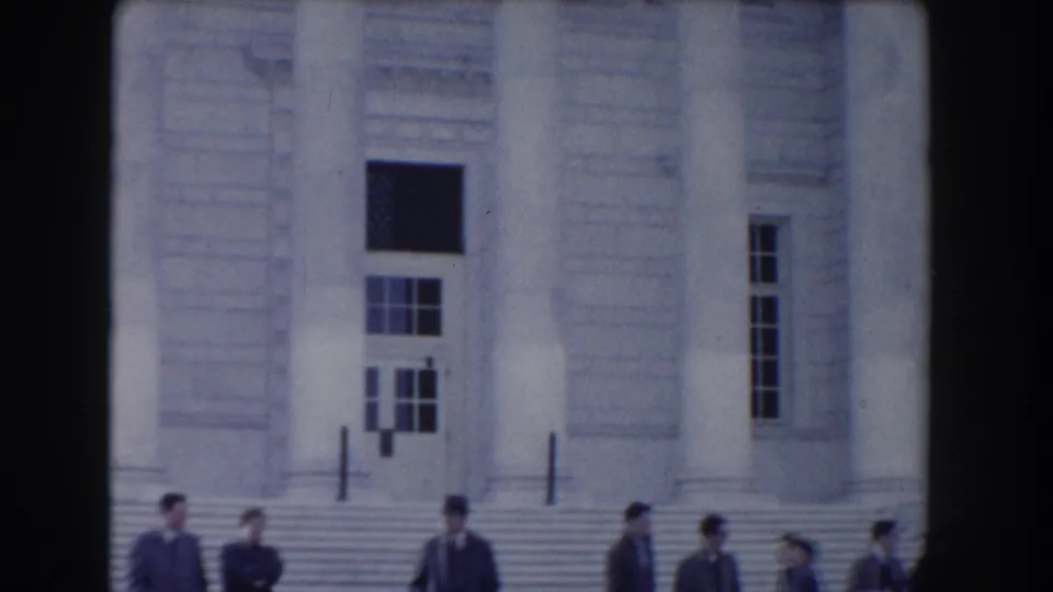 Closer 1960 Washington, DC home-movie view of the neoclassical entrance, with columns, windows, steps, and visitors partly visible below.