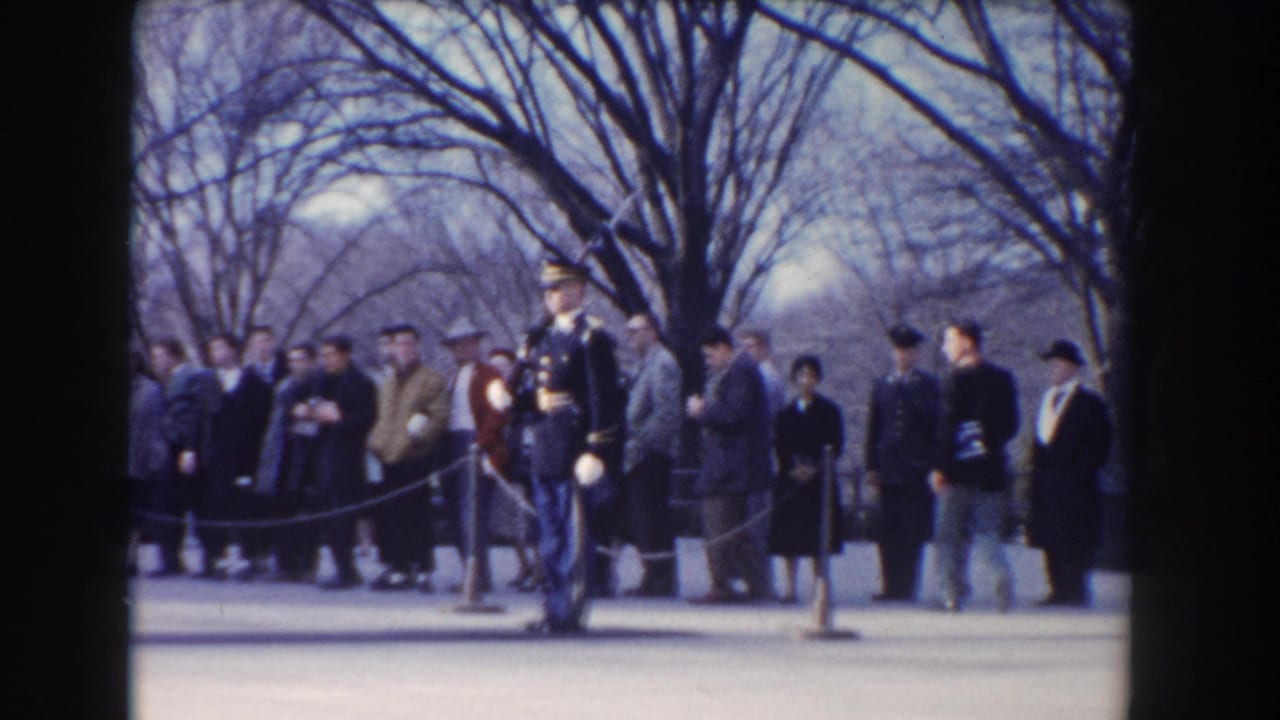 Ceremonial guard facing forward with civilians gathered behind a rope line.
