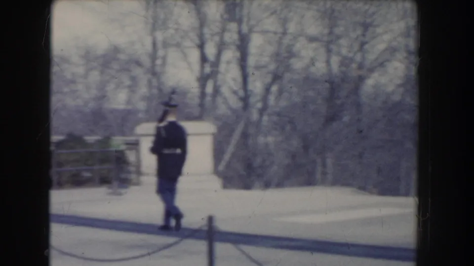 1960 Washington, DC footage appears to show a uniformed soldier walking across paved monument grounds in cold-season light.