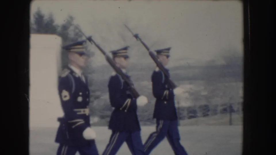 Washington, DC 1960 home-movie frame of three soldiers marching with rifles across an open public ceremonial area.