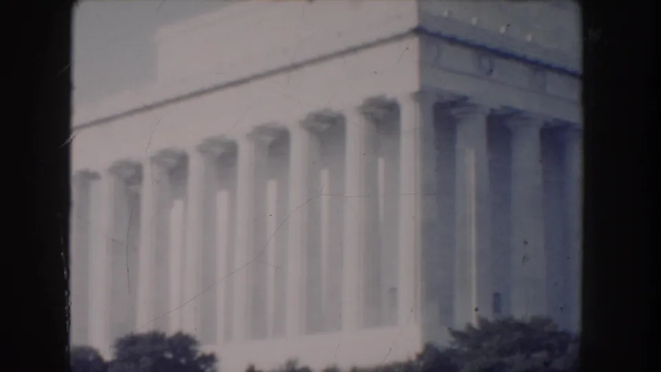 1960 Washington, DC frame with the Lincoln Memorial colonnade filling most of the view, softened by faded 8mm color.