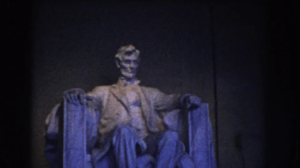 1960 Washington DC frame with the seated Lincoln statue more clearly lit against the Lincoln Memorial interior wall.