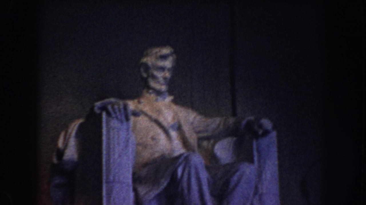 Seated Lincoln statue in the Lincoln Memorial, seen in a similar dim interior view.