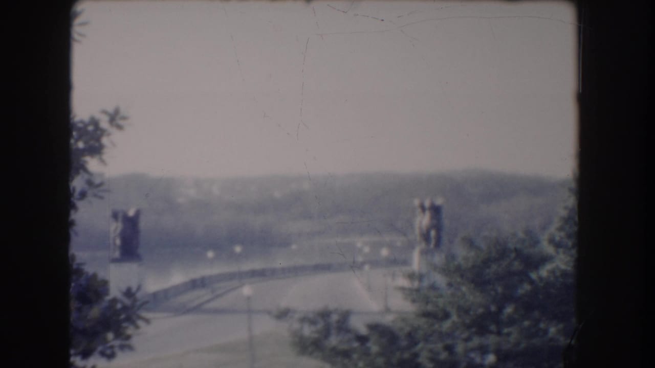 Distant Reflecting Pool area with trees, roadway, and dark film-frame borders.