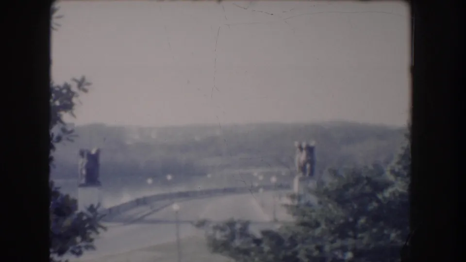 1960 Washington DC 8mm frame with a hazy distant view of the Reflecting Pool area, trees, and surrounding roads.