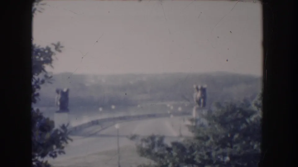 1960 Washington DC 8mm frame showing the Reflecting Pool area from an elevated, visitor-shot perspective with trees in the foreground.