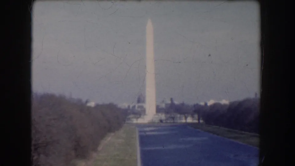 1960s Washington, DC home-movie view of the Washington Monument beyond the reflecting pool and bare trees.
