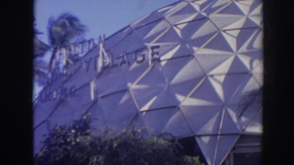1961 Hawaii 8mm frame showing Hilton Village lettering across the white triangular dome facade.