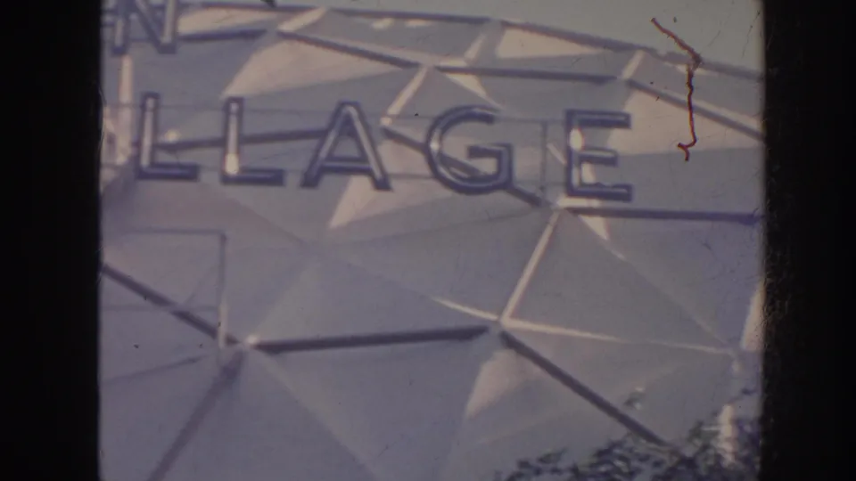 Final 1961 Hawaii frame showing cropped Village sign letters on the Hotel Hawaiian Village exterior facade.