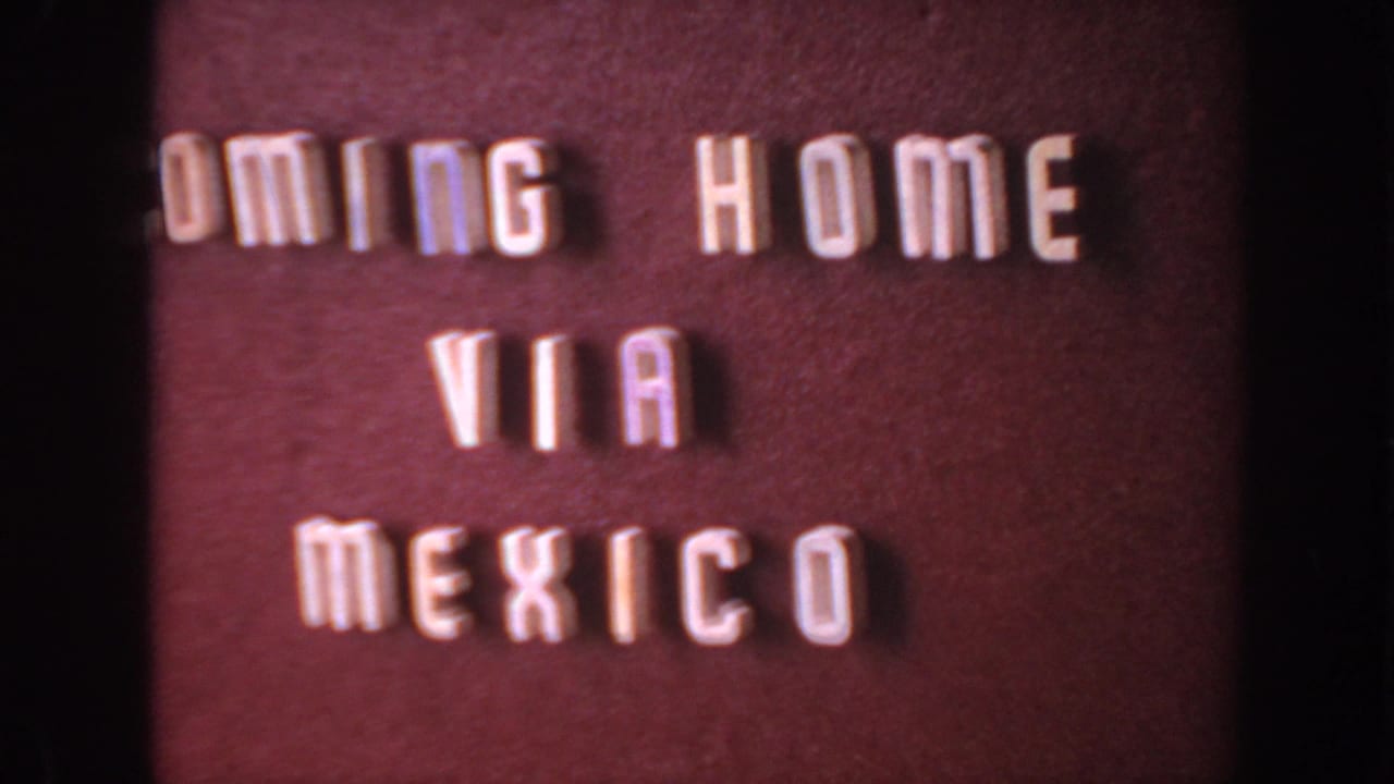 1961 8mm home-movie title card with white block letters spelling COMING HOME VIA MEXICO on a maroon background.