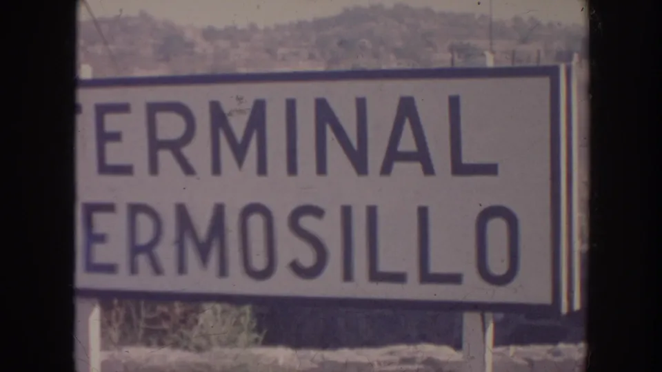 1961 8mm frame with the Terminal Hermosillo sign filling most of the view, cropped at the left edge.
