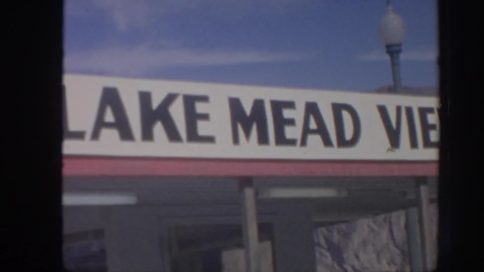 1962 Arizona travel frame showing a Lake Mead View sign under clear blue sky, with part of a lamp post above the sign.