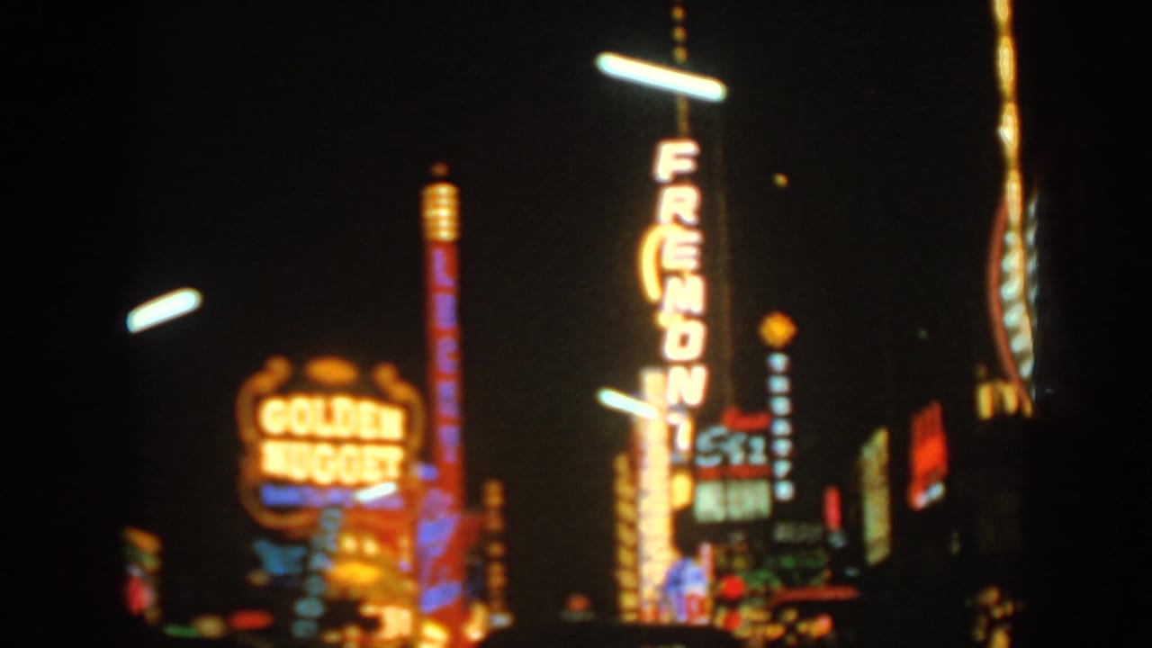 Nighttime Las Vegas neon with Golden Nugget and Fremont signs, captured in soft-focus 8mm color.