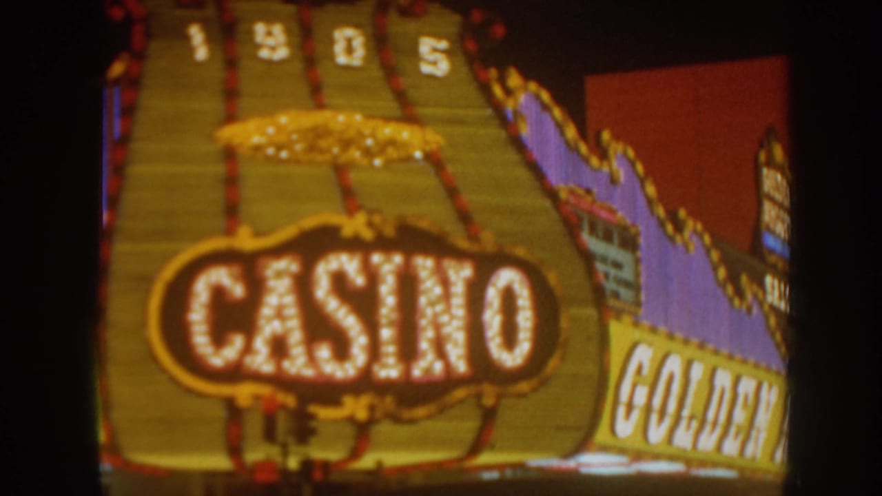 Golden Nugget casino sign and lit marquee bulbs against a dark night sky.