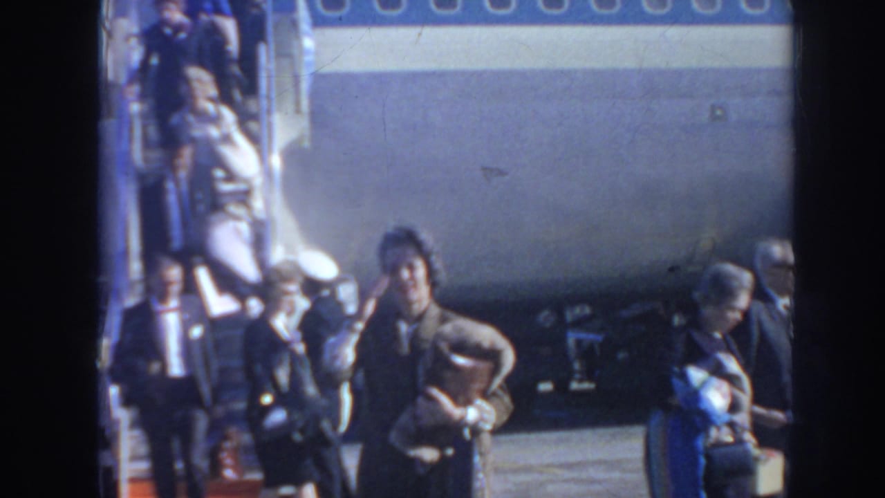 Passengers in period clothing disembark a Pan Am airplane on an Arizona airport ramp in 1962 home-movie footage.