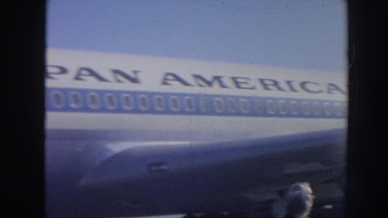 Pan American aircraft fuselage seen through dark film-frame borders.