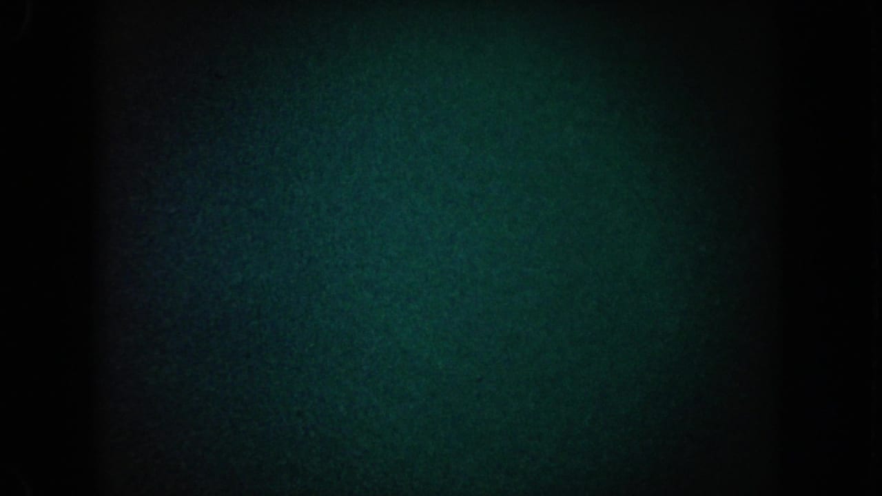 Dark blue-green grain field with black edges and a central vertical shadow.