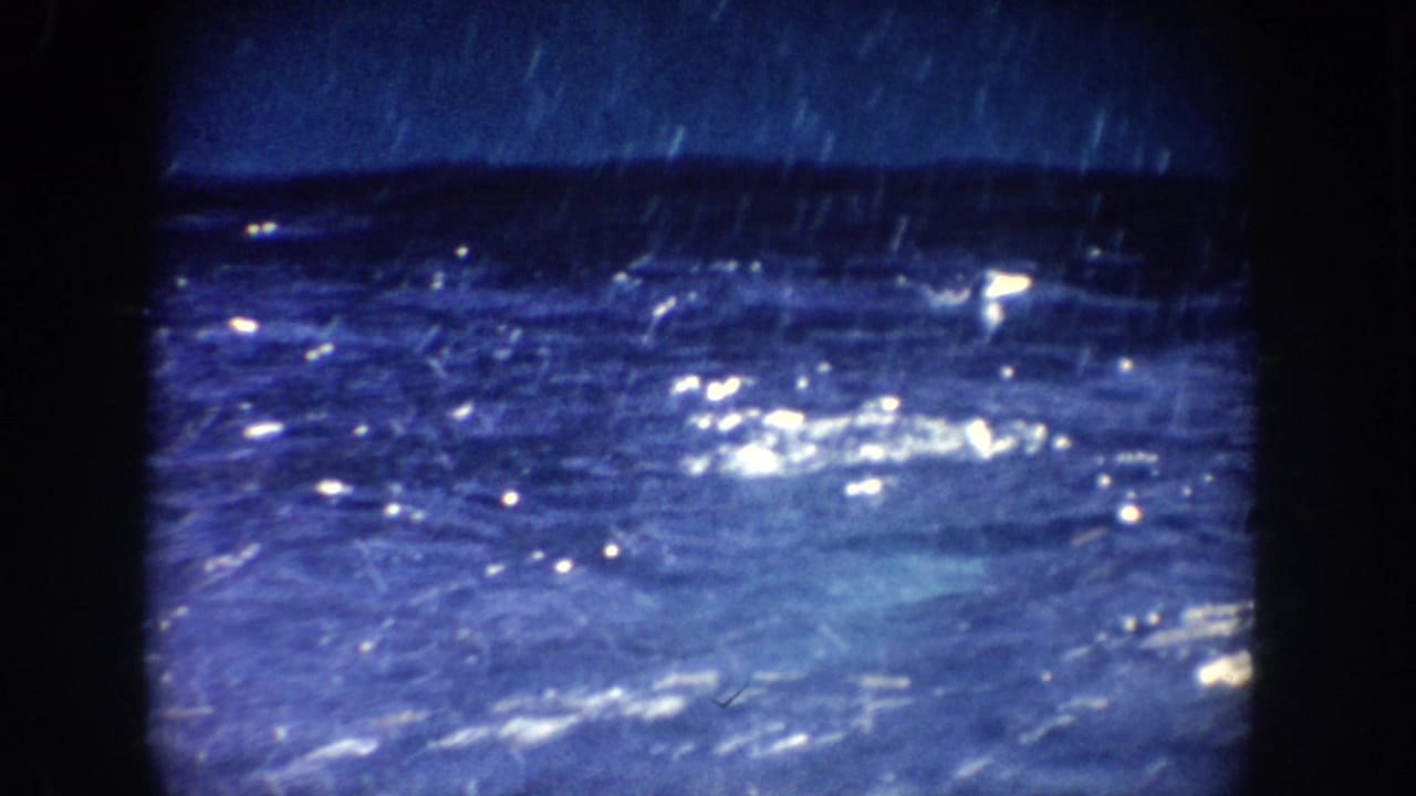 Blue pool water with bright surface reflections and dark film borders.