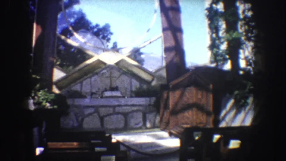 Stone chapel with cross and timber details seen from a vehicle during a 1962 California road trip.