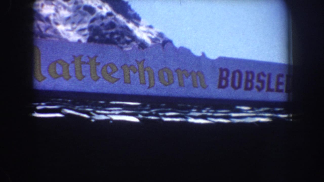 1962 Anaheim home-movie frame showing part of a Matterhorn Bobsleds banner beneath an Alpine mountain facade.