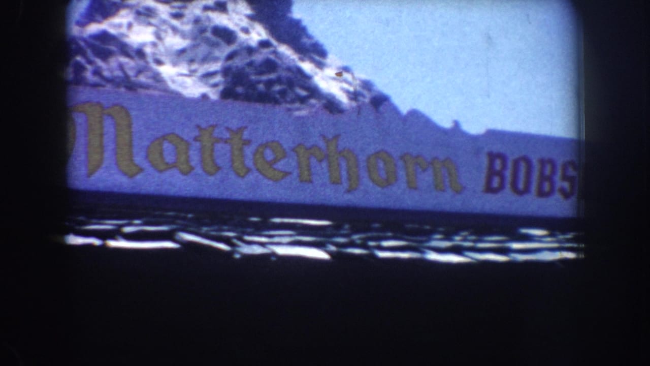 Matterhorn Bobsleds banner and snowy mountain artwork framed by dark film edges.