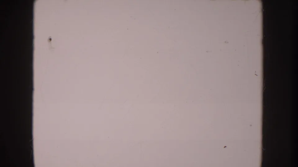 Anaheim 1962 8mm frame remains blank and faded, with visible dust, faint scratches, edge shadowing, and a horizontal contact-sheet seam.
