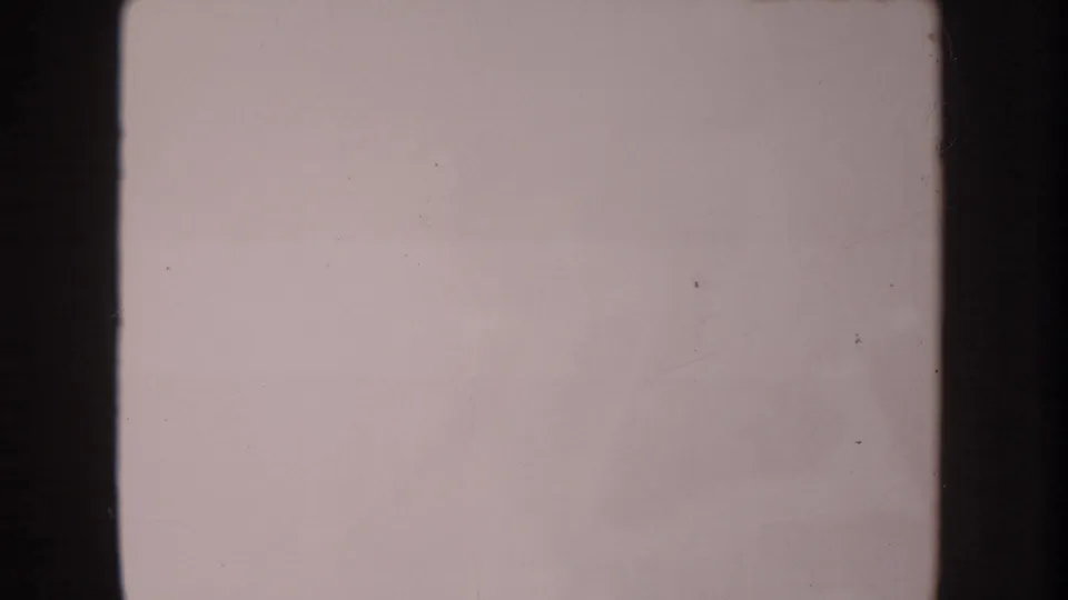 Overexposed 1962 8mm home-movie frame from the Anaheim reel with pale color, dark gate edges, and light surface wear.