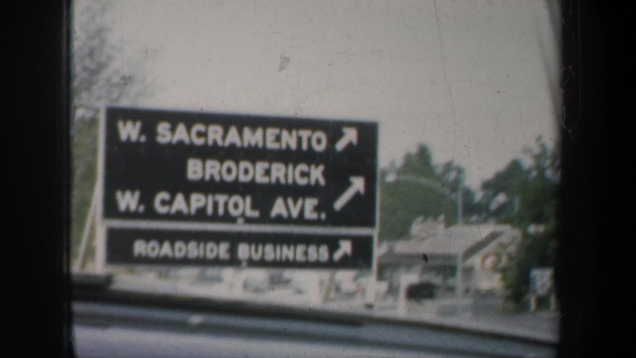 Directional road sign seen through a car window, listing W. Sacramento, Broderick and W. Capitol Ave.