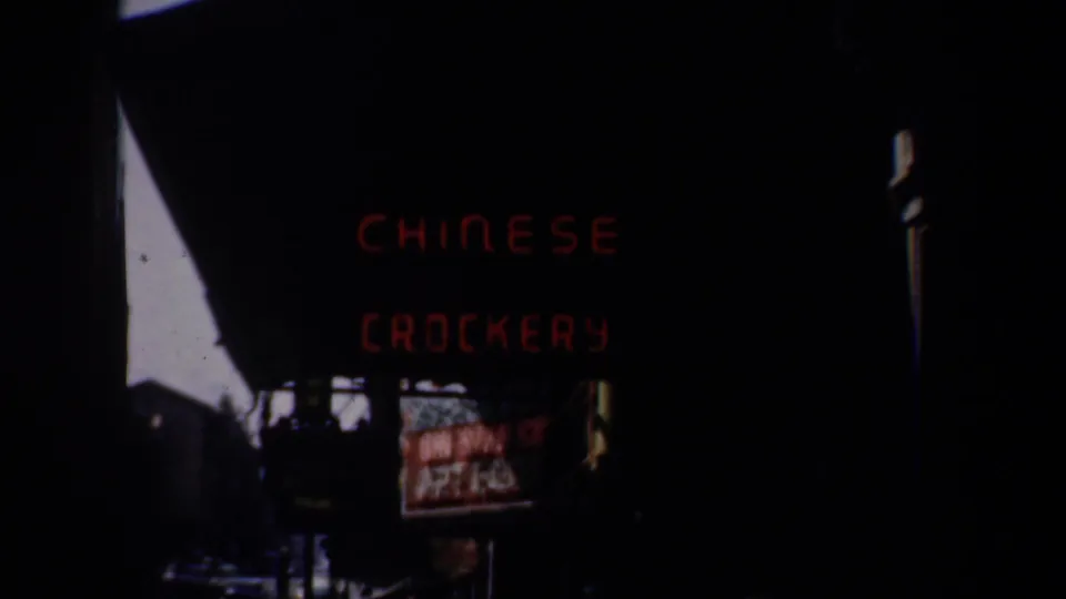 A red Chinese Crockery sign appears in a dark San Francisco street view, likely near Chinatown, with no people visible.