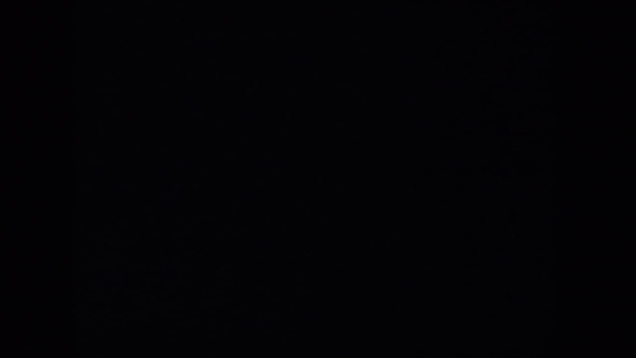 Mostly dark frame with little visible landscape detail.