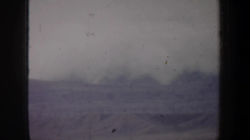 The final 1957 Portland metadata frame shows a faint mound or mountain-like shape through haze, with heavy scratches and dust visible.