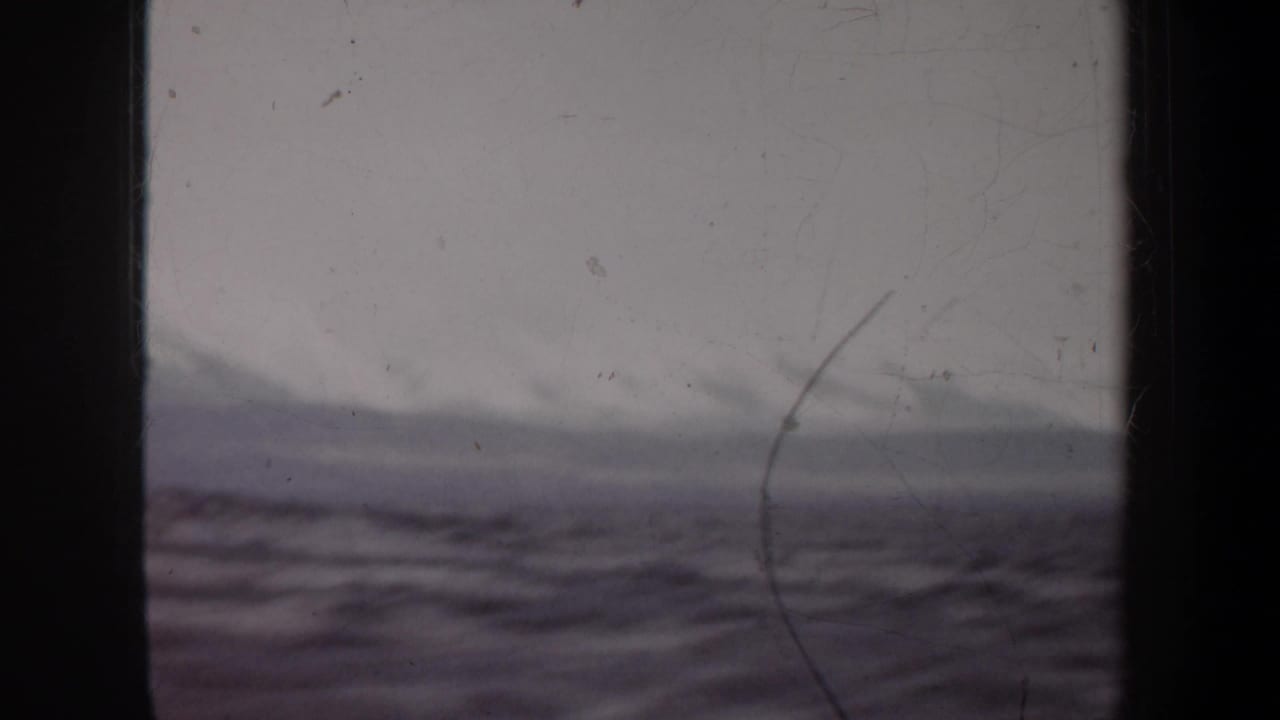 Open water and distant hazy shoreline or horizon behind dark framing.