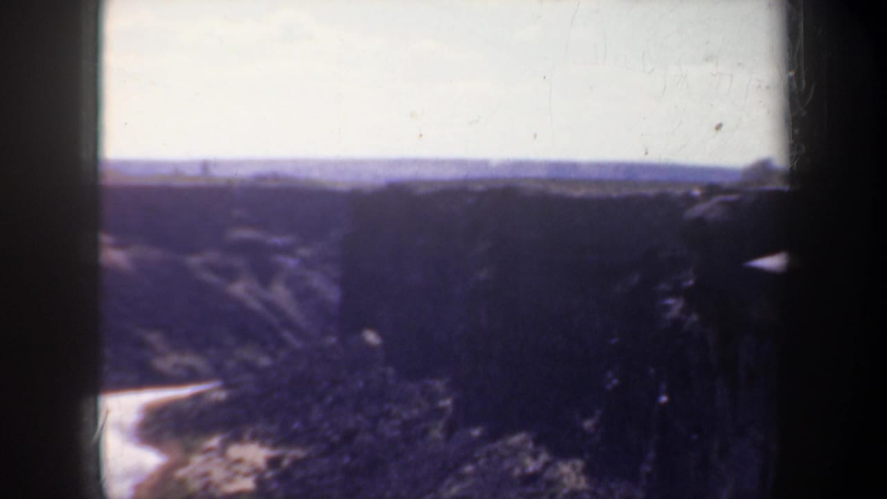 Canyon landscape with a winding river beginning to appear below.