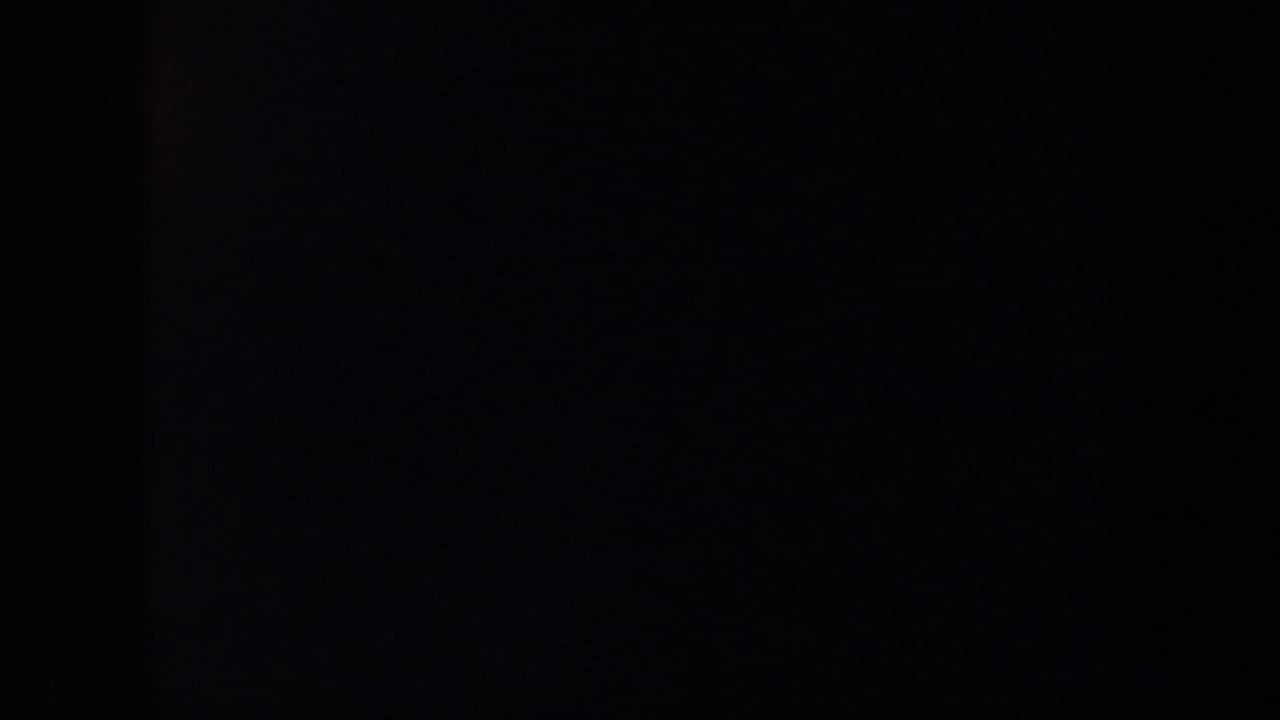 Mostly dark frame with little visible detail.