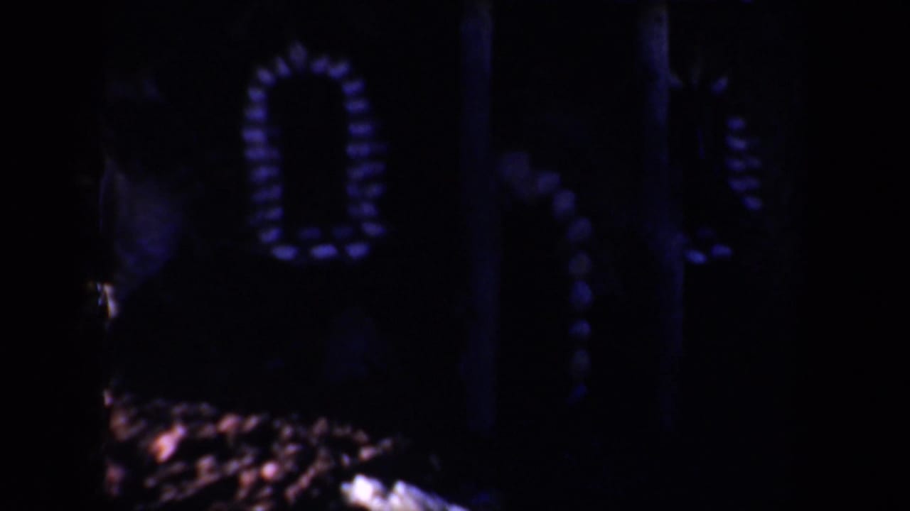 Dark decorative structure with pale arched patterns and very low exposure.