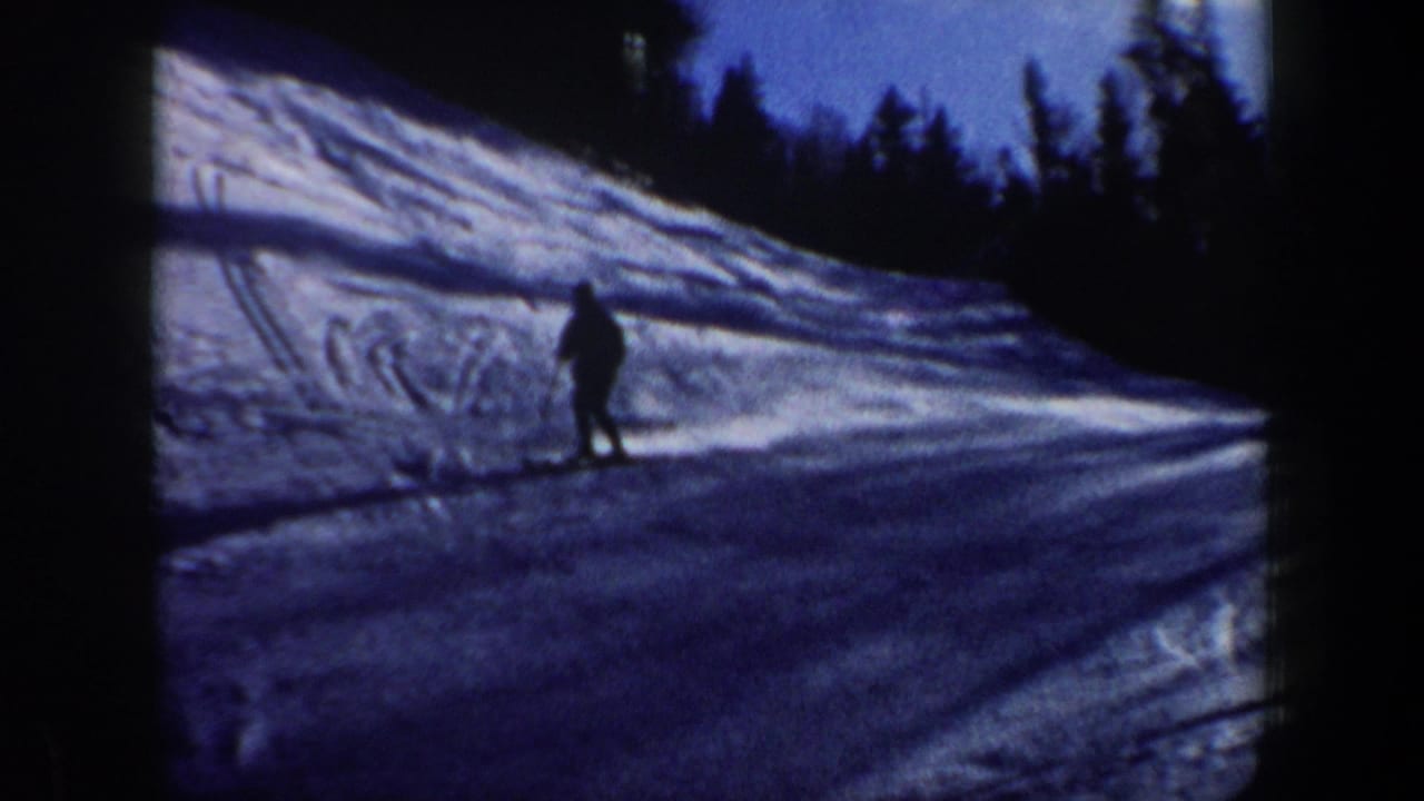 A lone skier nears the lower part of the slope in soft 8mm footage from 1962 New Hampshire.