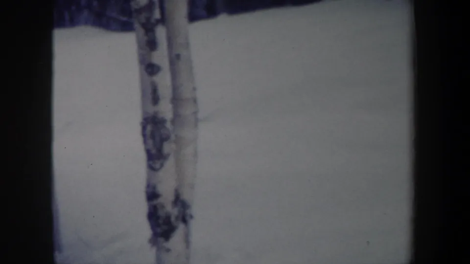 1962 New York 8mm frame showing the snowy slope after the skier has moved out of view or become indistinct.