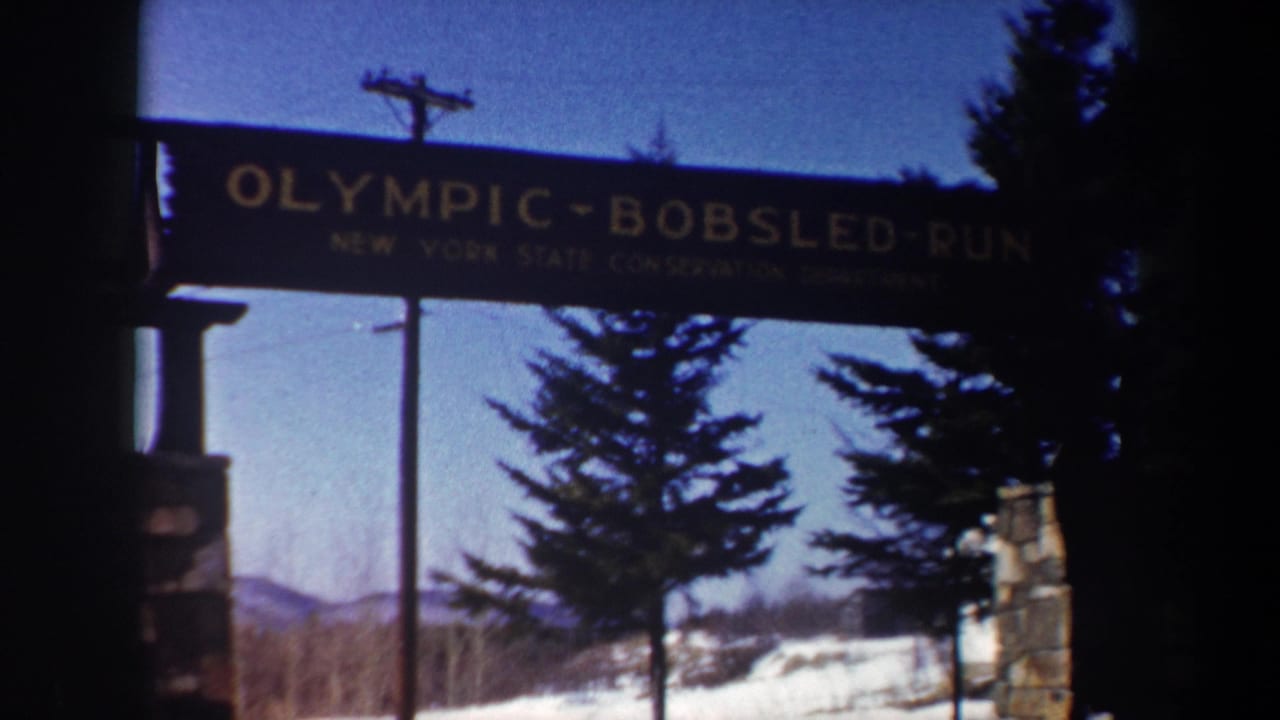 Olympic Bobsled Run sign spanning a snowy entrance with trees behind it.