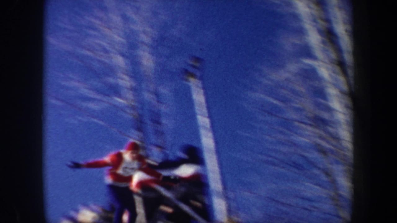 A skier in red and white appears airborne near a jump structure during a 1962 New York winter sports scene.