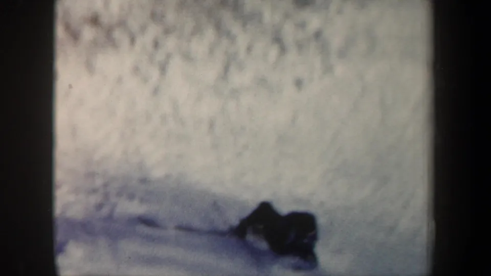 Final frame shows a dark figure or equipment on the snowy landing slope, suggesting the aftermath of the jump.