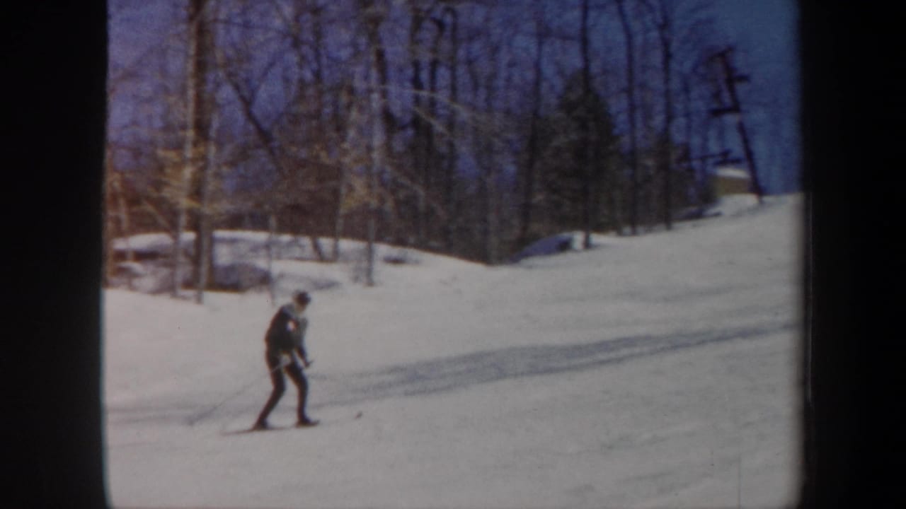 1962 Vermont frame with a skier practicing on a bright snowy hillside near leafless trees and a visible utility pole.