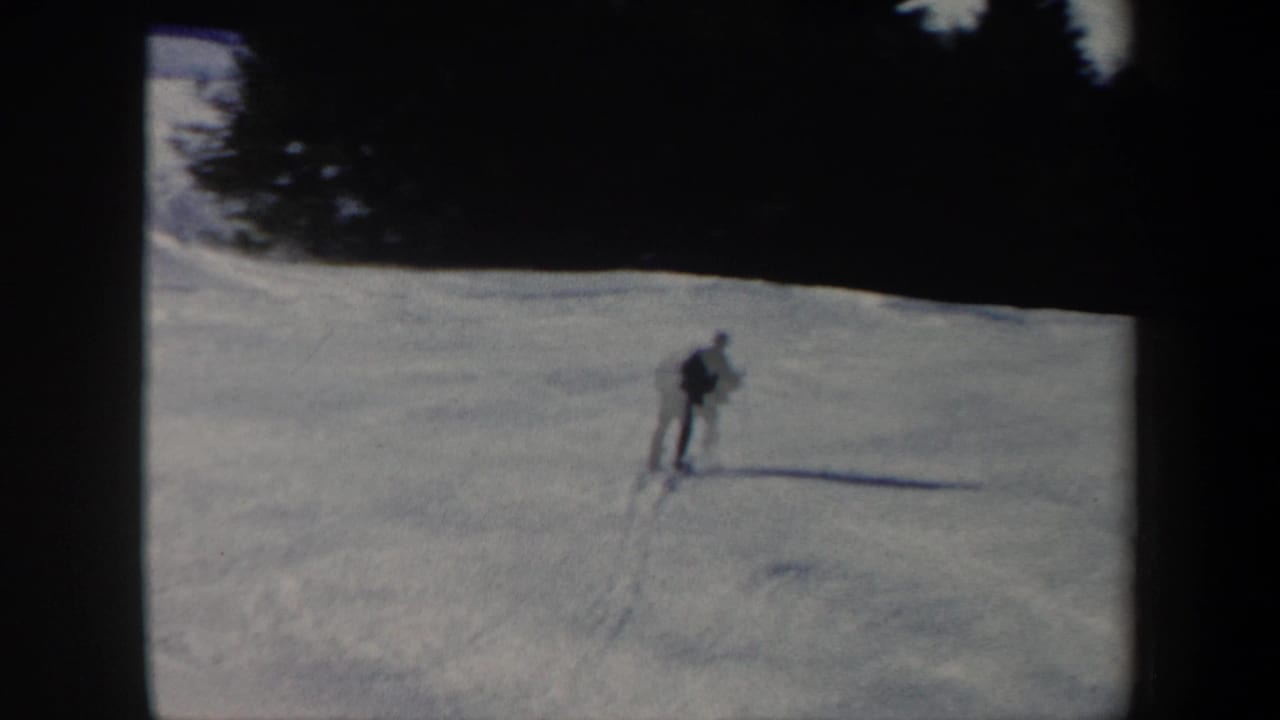 Distant view of a skier moving across a broad Vermont snow slope in 1962 home-movie footage.