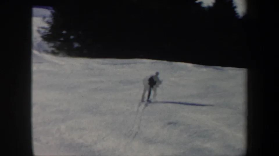 Distant view of a skier moving across a broad Vermont snow slope in 1962 home-movie footage.