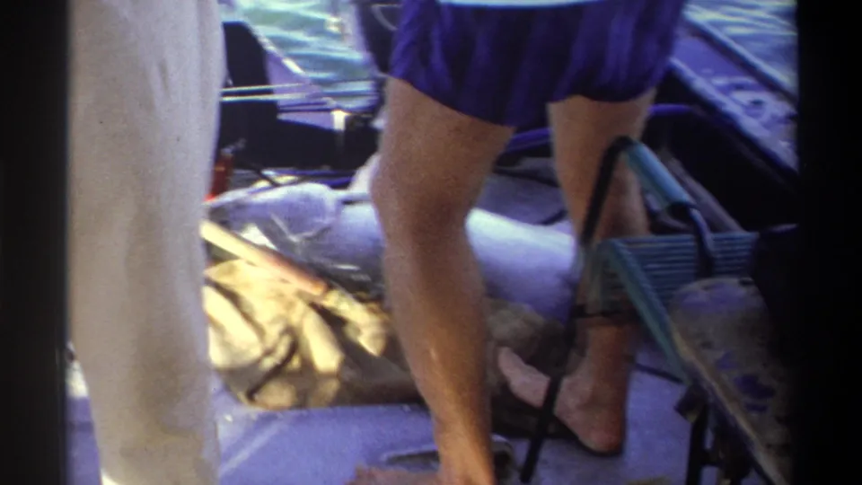 A large catch rests on the deck of a small boat in 1969 Nigeria, with adults and gear partly visible around it.