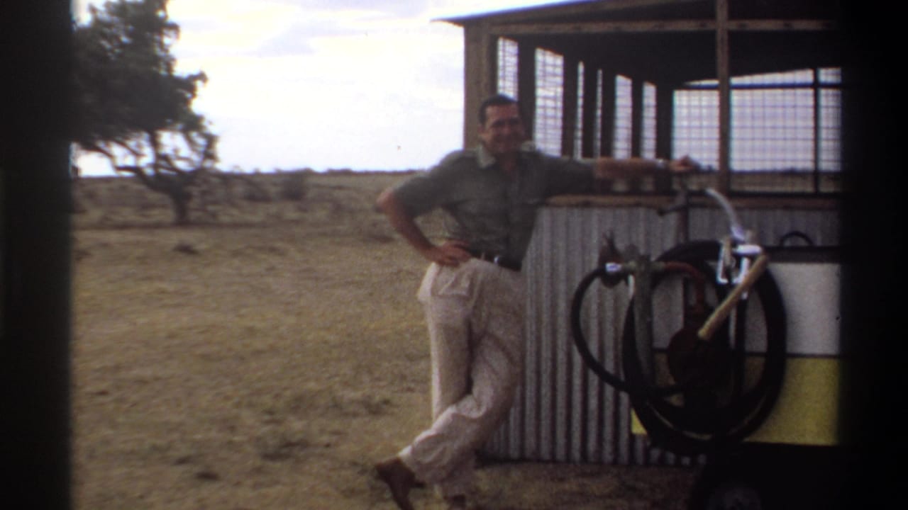 The final 1969 Nigeria frame shows a man beside a corrugated structure with wheel hardware, wire panels, dry ground, and a tree at left.