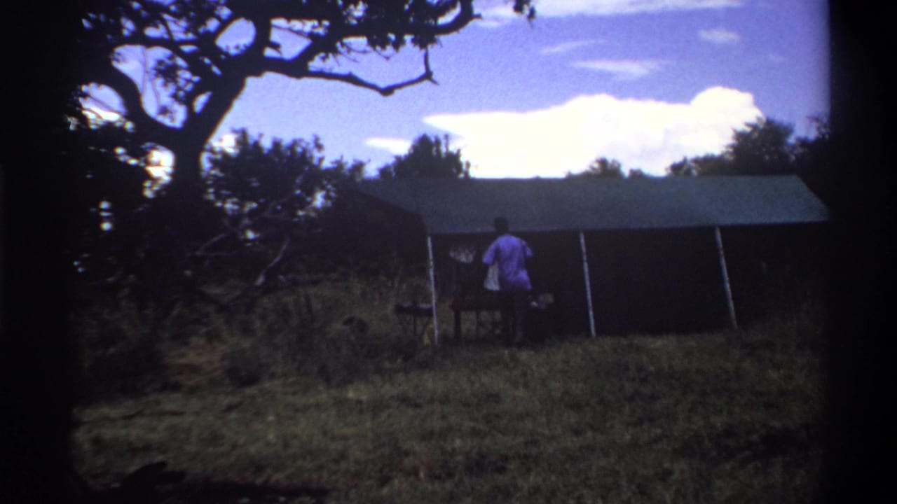 Man nears a canvas tent entrance with a table nearby.