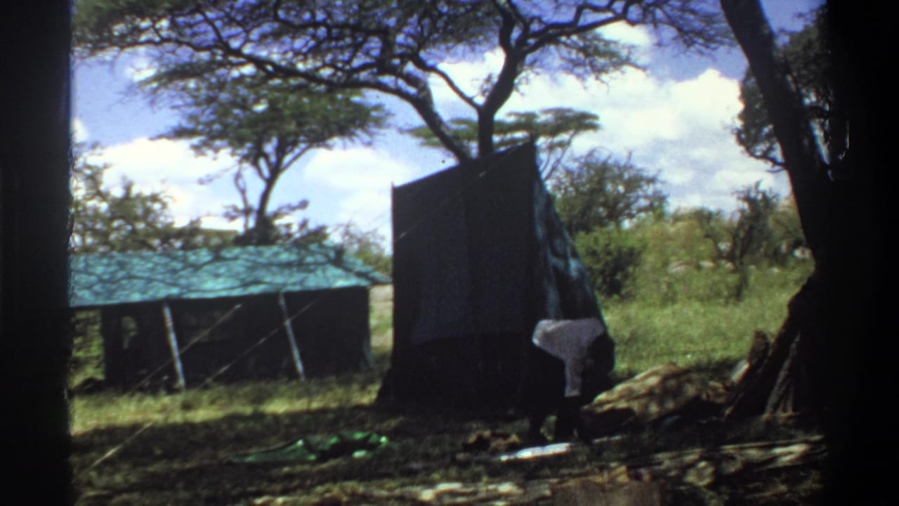 A dark tent or awning panel is raised in the Lagos outdoor setting, with one man partly visible near its base.