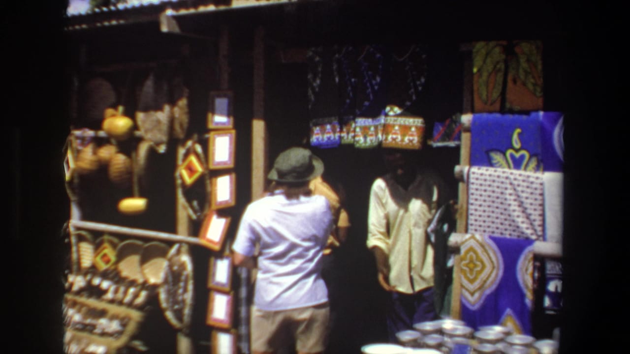 In Pretoria, South Africa, 1969, a hat-wearing woman faces a shaded craft stall with woven baskets, patterned textiles, and metal bowls.